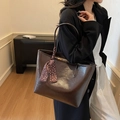 Deep brown oversized tote bag in faux leather featuring a stylish polka dot scarf detail - Brown