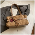 Detail of brown faux suede bag featuring belt buckle, bear charm, and fringe tassels - Khaki with Pendant