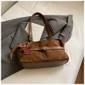 Detail of brown suede tote bag with belt buckle decoration and heart charm on grey blazer - Brown with Pendant