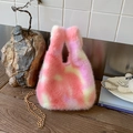 Close-up of pink and purple fuzzy plush bag showing soft texture and gold chain link - Pink