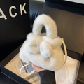 Chic white faux fur bucket bag featuring a large decorative bow and crossbody strap - White