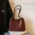Retro burgundy suede tote bag with woven handles and a decorative beaded charm - Burgundy