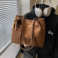Brown faux leather tote bag featuring woven rope handles and wooden bead charm detail - Brown