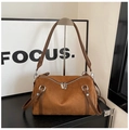 Detail of vintage brown suede pillow bag featuring silver hardware and a side shoulder strap - Brown