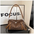 Detail view of leopard print texture with brown leather handles and silver zipper - Leopard Coffee