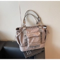 Macro shot of waterproof nylon travel bag with separate bottom zipper compartment - Khaki