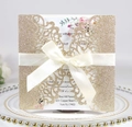 Detailed laser-cut gold glitter wedding invitation with elegant white satin bow - Glitter Rose Gold