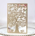 Close-up of glitter gold laser cut tree design wedding invitation with floral insert card - Glitter Rose Gold