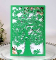 Detail of laser-cut green tree and bird pattern on an elegant invitation card - Dark Green