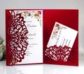 Macro shot of laser-cut burgundy wedding invitation set with floral inner card detail - Pearlescent Red