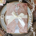 Detail of rose gold glitter laser-cut wedding invitation with cream satin ribbon bow - Glitter Champagne Gold