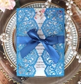 Detail of blue glitter laser cut wedding invitation with navy ribbon and floral insert - Glitter Royal Blue