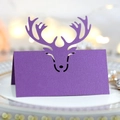 Purple laser-cut reindeer place card on elegant dinner plate for Christmas wedding table decor - Dark Purple
