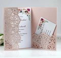 Detail view of laser-cut floral wedding invitation set with pearl pink pocket and inserts - Nude Pink