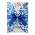 Macro detail of laser cut glitter wedding invitation with blue satin ribbon and floral card - Glitter Royal Blue