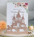 Macro view of rose gold glitter laser-cut castle and pumpkin carriage wedding invite - Glitter Champagne Gold