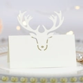 White laser-cut reindeer place card with fold-out deer antler design for holiday tables - Ivory