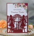 Detail view of burgundy laser-cut fairy castle invitation on elegant white plate - Dark Red