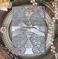 Detail of laser-cut glitter wedding invitation with elegant silver silk ribbon bow - Glitter Charcoal Silver