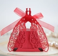 Elegant red laser-cut peacock wedding favor box with ribbon on decorative plate - Pearlescent Red