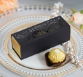Detail of luxury laser-cut black flower gift box with gold interior and pearl accents - Black