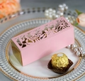 Pink laser-cut rose floral gift box for wedding favors placed on a luxury pearl plate - Pink