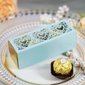 Detail of light blue laser-cut heart favor box with gold trim on a white plate - Pearl Pale Blue