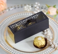Macro view of laser-cut wedding candy box with elegant cross pattern and gold lining - Black