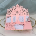 Detail of pink laser-cut 3D wedding invitation with floral patterns and gold-rimmed plate - Pink
