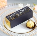 Macro detail of laser-cut black and gold wedding favor box with ornate scroll patterns - Black