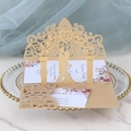 Detail of laser-cut silver wedding invitation with silhouette design and floral inserts - Beige Gold
