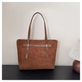Close-up of brown suede tote bag featuring decorative straps and vintage metal buckles - Brown