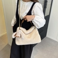 Beige faux fur tote bag with chain strap and cute rabbit pendant on a model's shoulder - With Rabbit Charm / Apricot
