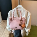 Pink faux suede bucket bag with shearling trim and decorative heart pendants - With Charm / Pink