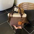 Brown suede bucket bag with lamb wool trim and decorative heart bag charm - With Charm / Brown