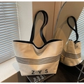 Large cream canvas tote bag with black stripes and ZYS lettering on a wooden table - Off White