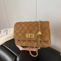 Brown quilted suede crossbody bag with gold chain strap and twist lock detail - Yellow Brown
