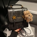 Retro black leather backpack with gold brand logo, star studs and plush dog charm - With Charm / Black