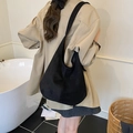 Minimalist black faux suede hobo bag with wide shoulder strap and spacious design - Black