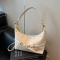 Cream white minimalist faux leather dumpling bag with textured pleats and golden hardware - White