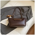 Detail shot of a dark brown woven shoulder bag with elegant wooden bead charms - Coffee With Pendant
