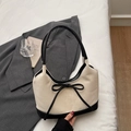 Minimalist cream and black contrast shoulder bag with a bow accent and top handle - Off-white