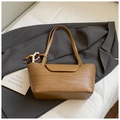 Detail of brown woven shoulder bag featuring leather trim and wooden bead pendant - Khaki With Pendant