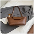 Brown woven texture underarm tote bag with wooden bead charm on a grey blazer - Brown with Pendant