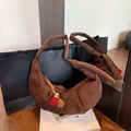 Brown suede crescent shoulder bag with pleated details and colorful pompom charm - Brown with Pendant
