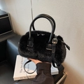 Chic black faux fur handbag with leather handles and adjustable shoulder strap - Black