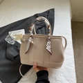 Beige faux leather bucket bag with scarf-wrapped handle and crossbody strap accessory - Off-white