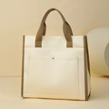 Detail of canvas tote bag with front pocket, metal snap button and dark brown handles - Off White