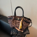 Leopard print bucket bag with black leather handles and colorful beaded charm strap - Black with Pendant