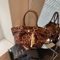 Leopard print bucket bag with brown leather handles and decorative ethnic bead charm - Brown with Pendant